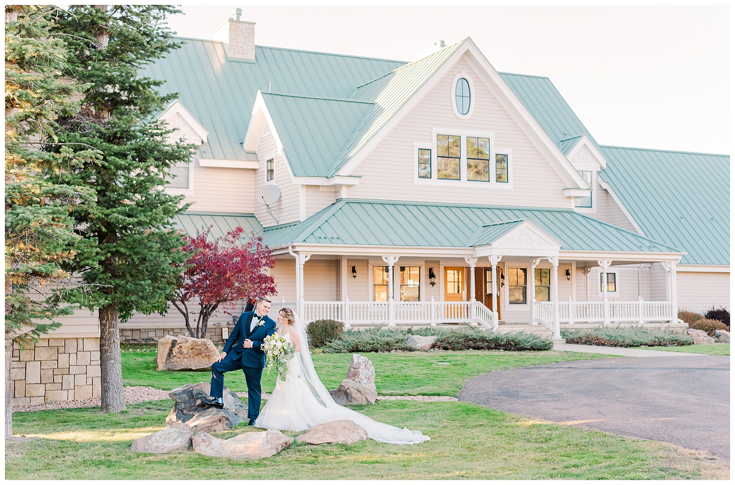 bride and groom stand outside of their venue, Flying Horse Ranch, a castle Rock wedding venue