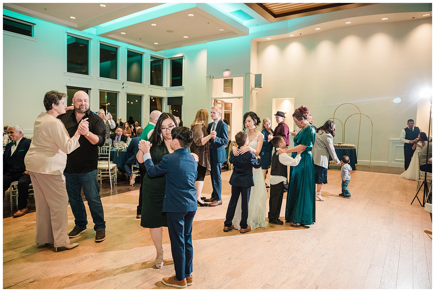 Wedding guests dance inside the reception space of Ashley RIdge, a castle rock wedding venue