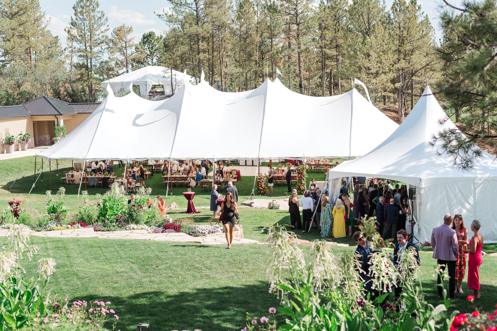 A photo of a large outdoor tent for hosting parties sits on the golf course at Castle pines for a wedding reception, a castle rock wedding venue