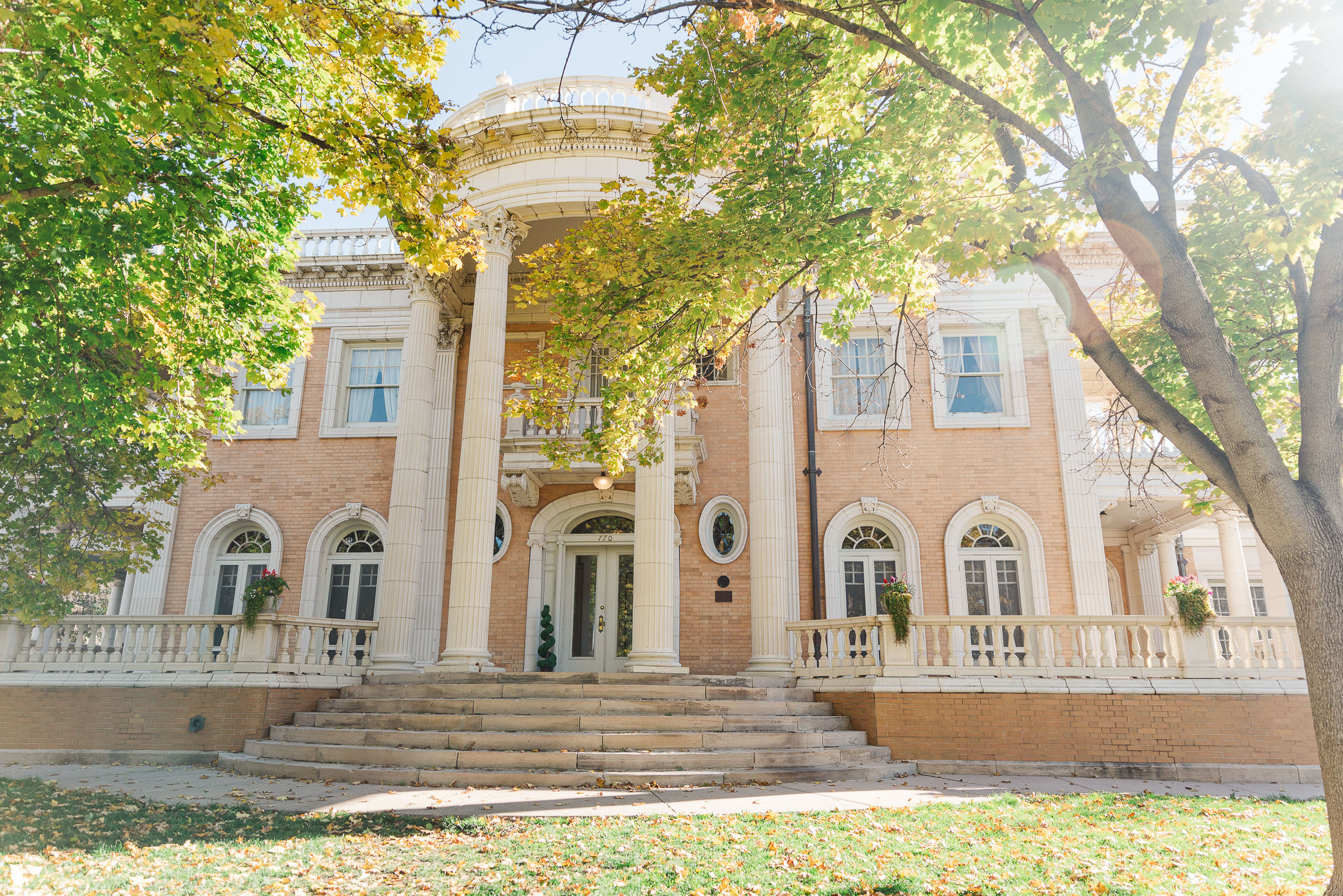 Grant Humphreys Mansion Wedding venue with details of the outside of the building with large trees and a stairway up to the front of the building