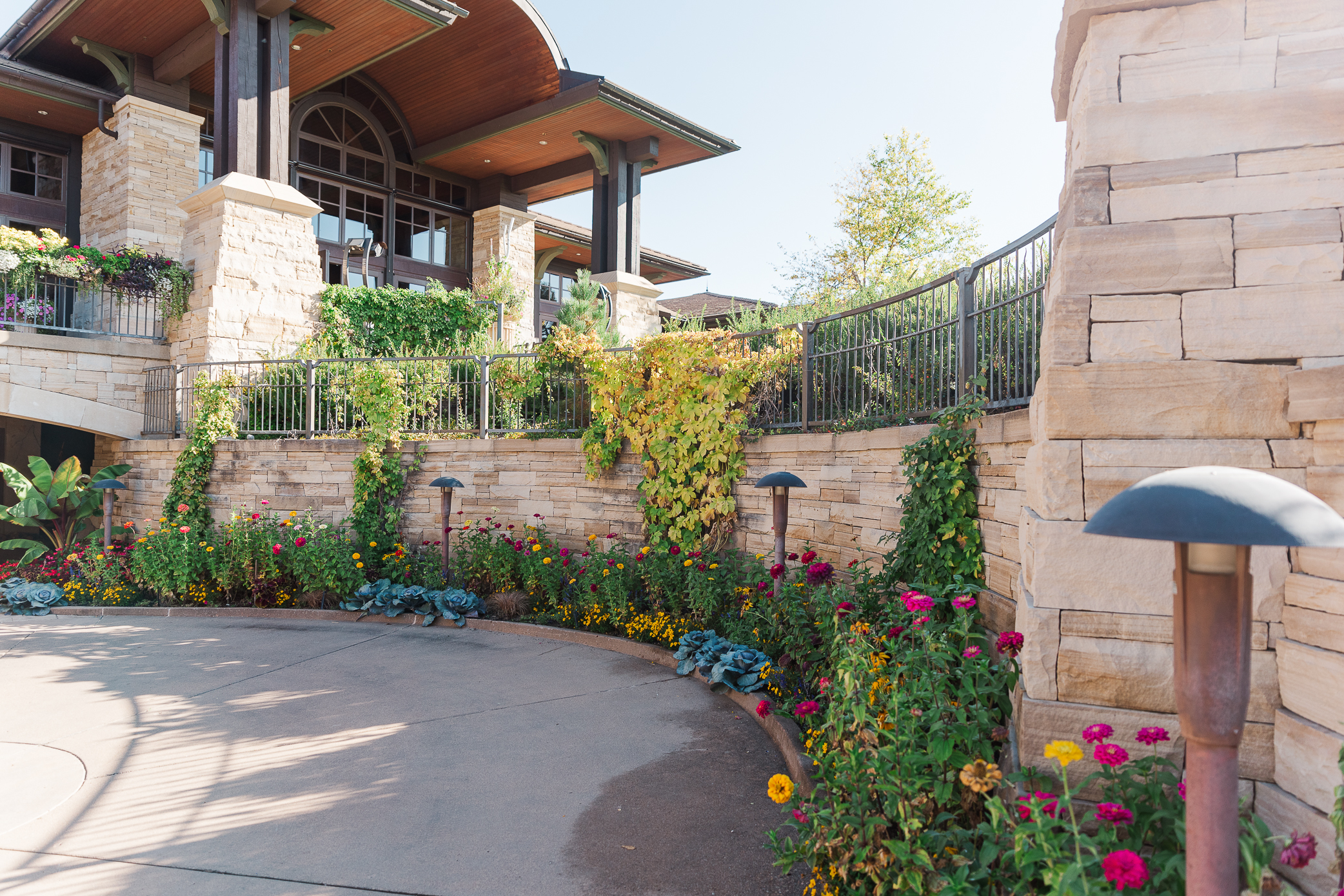 One of the walls lining Sanctuary Golf Course with plenty of colorful flowers