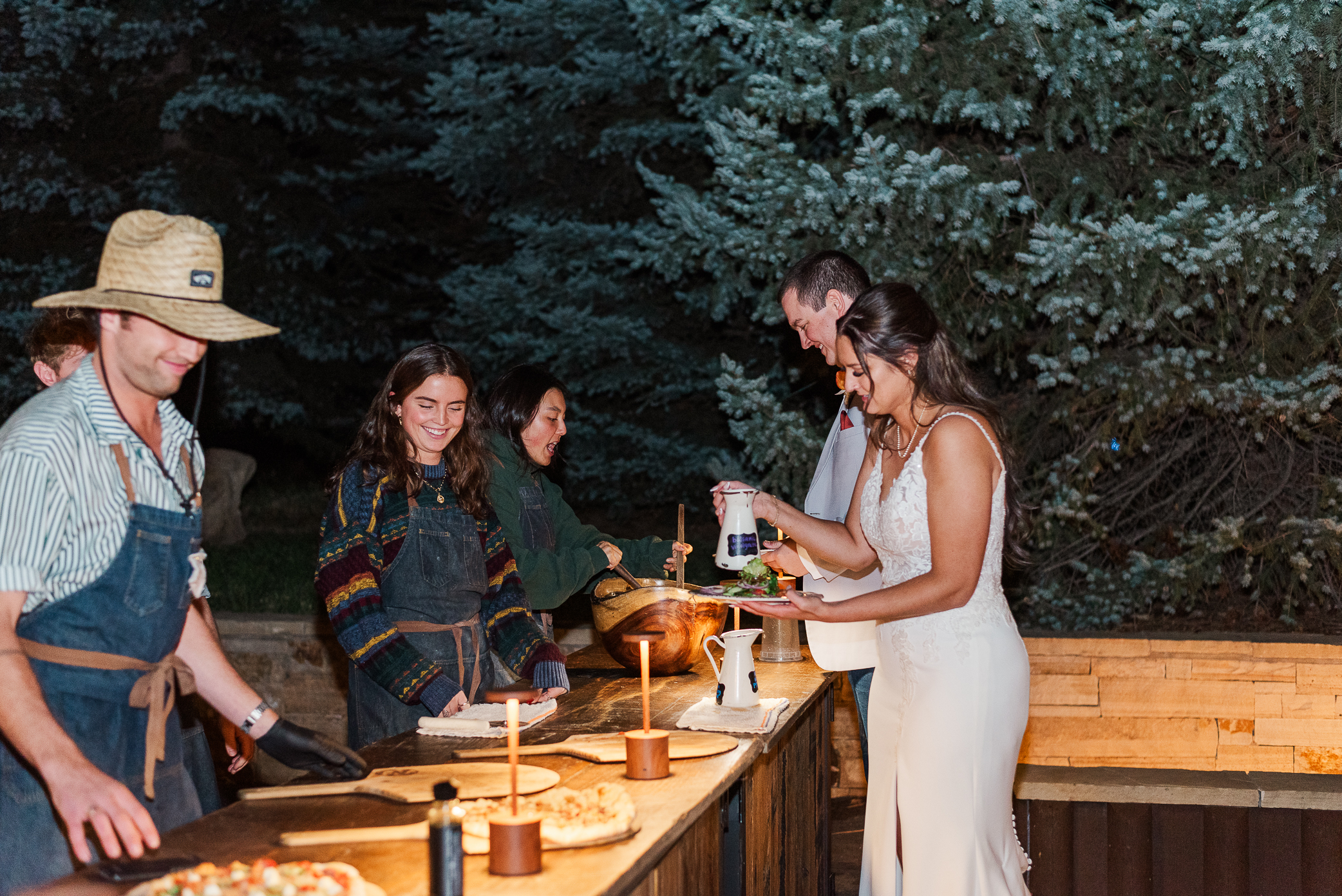 A bride and groom finish up their pizza creations for their guests to eat at Mountain crust event venue