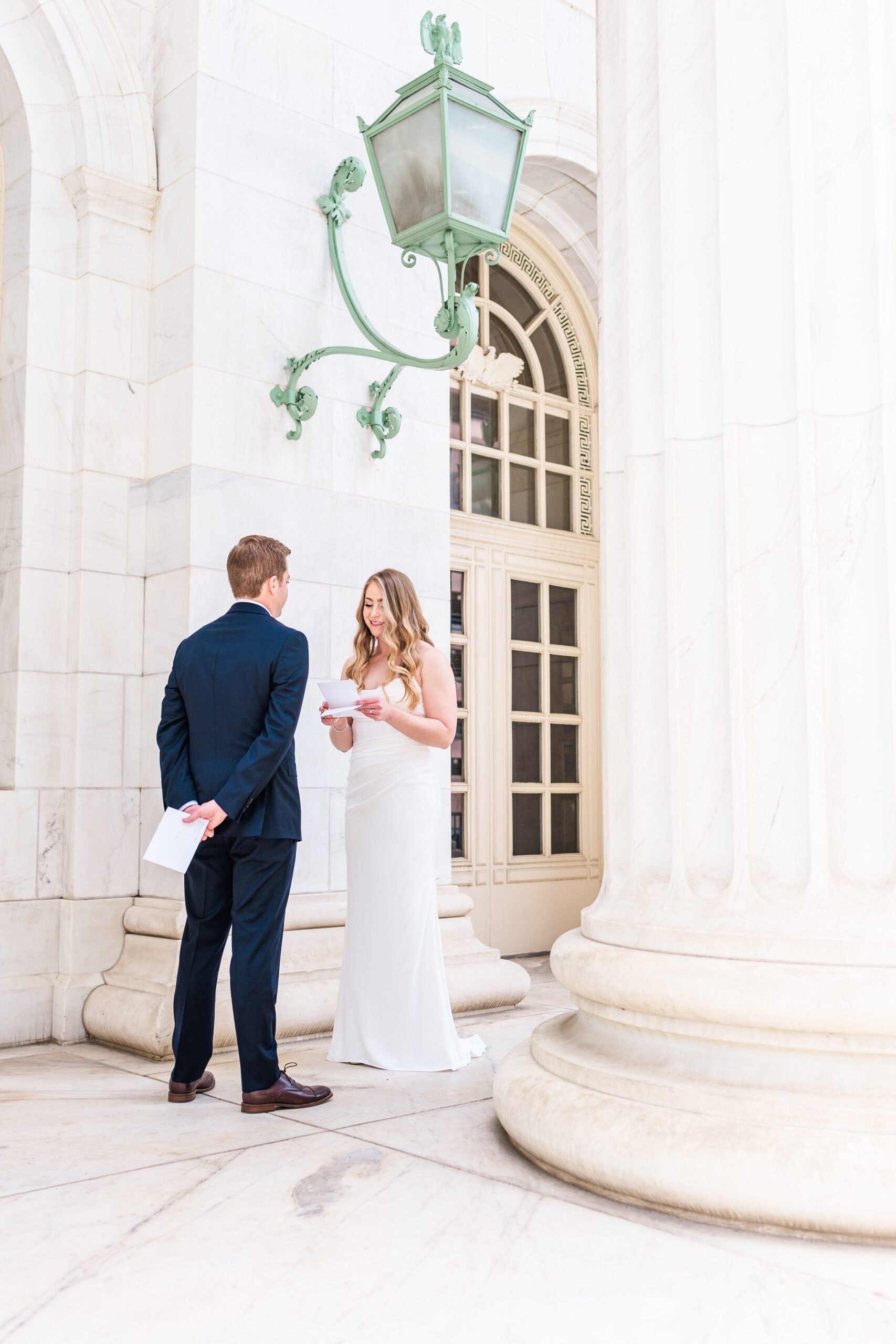 A bride and groom exchange vows on the front patio area for their Byron White Courthouse wedding