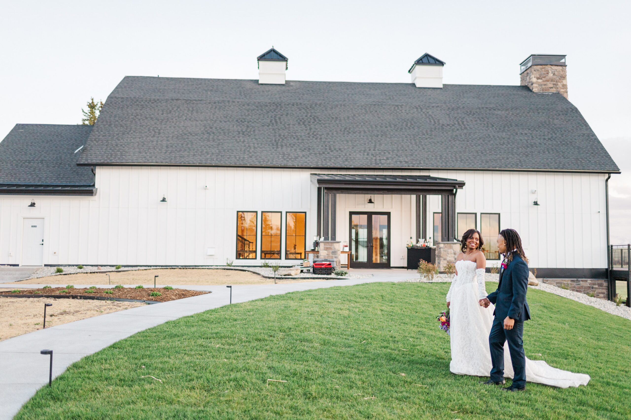 Front of Cherry valley venue with a couple walking down the grassy hill