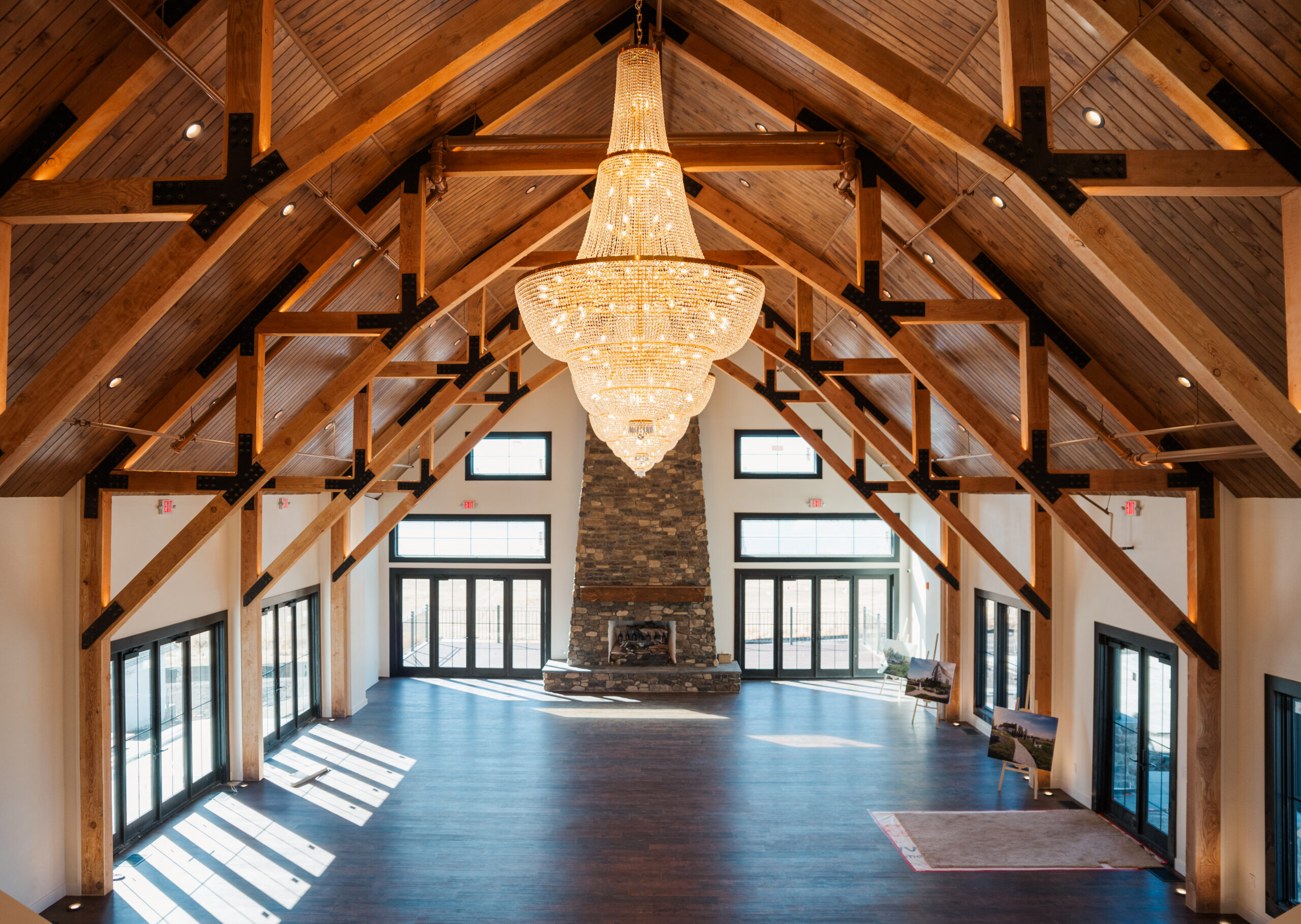 THe inside area of Cherry Valley venue complete with large chandeliers and chic french country charm